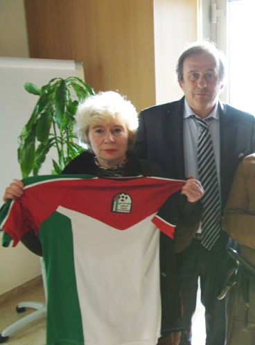 Michel Platini obliged to share the limelight with a Palestinian football shirt held by French campaigner Olivia Zemor